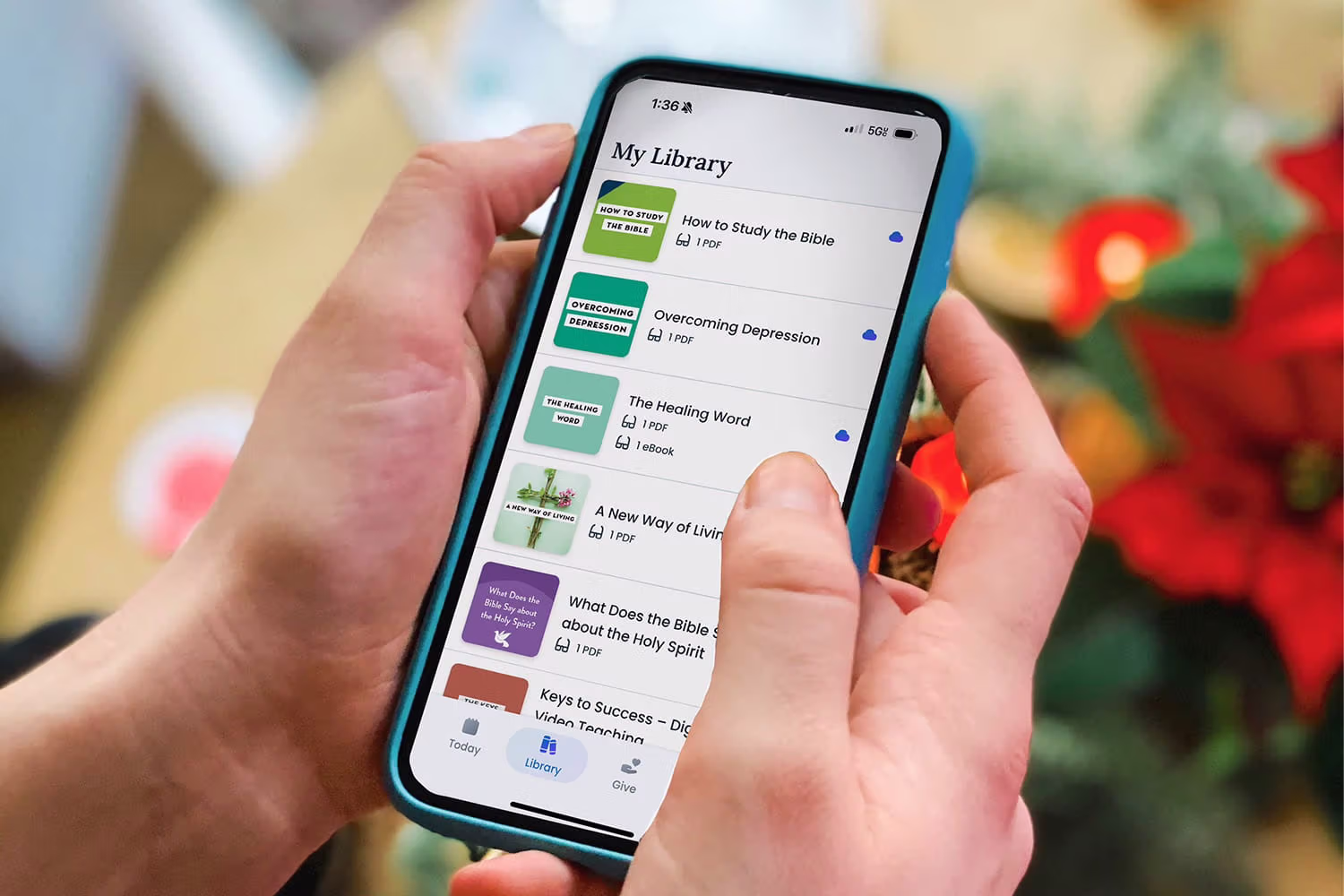 A person holding a phone with the Joyce meyer App on it.