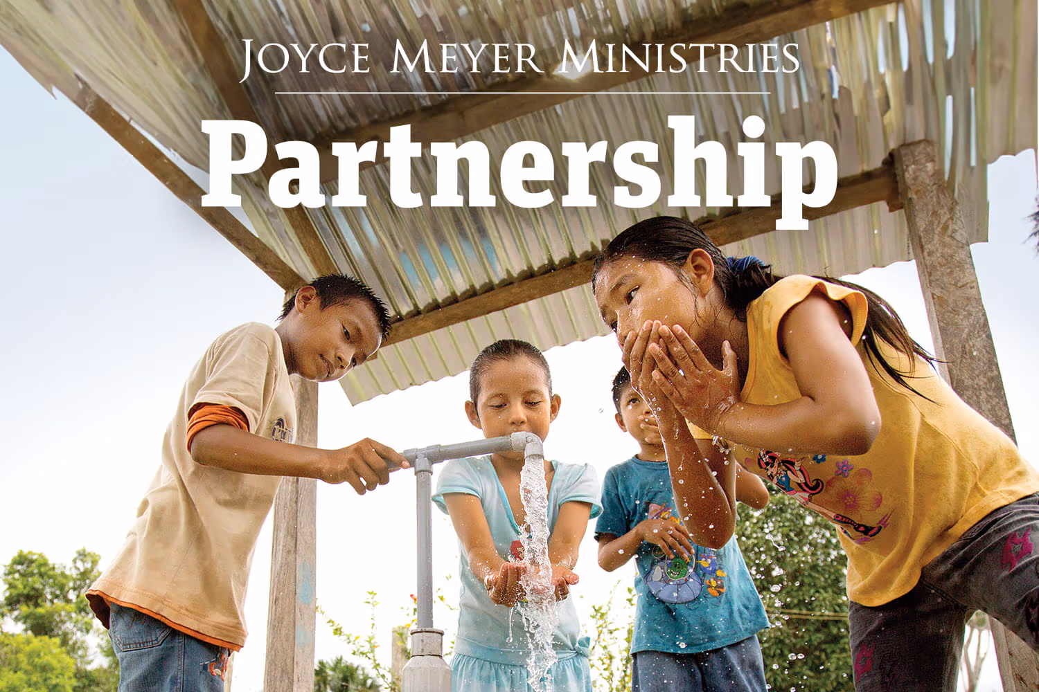 Kids drinking from a water well