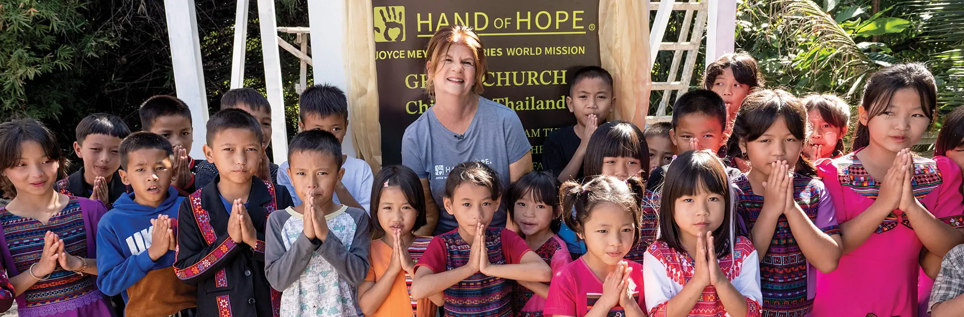 Image of Ginger Stache surrounded by children.