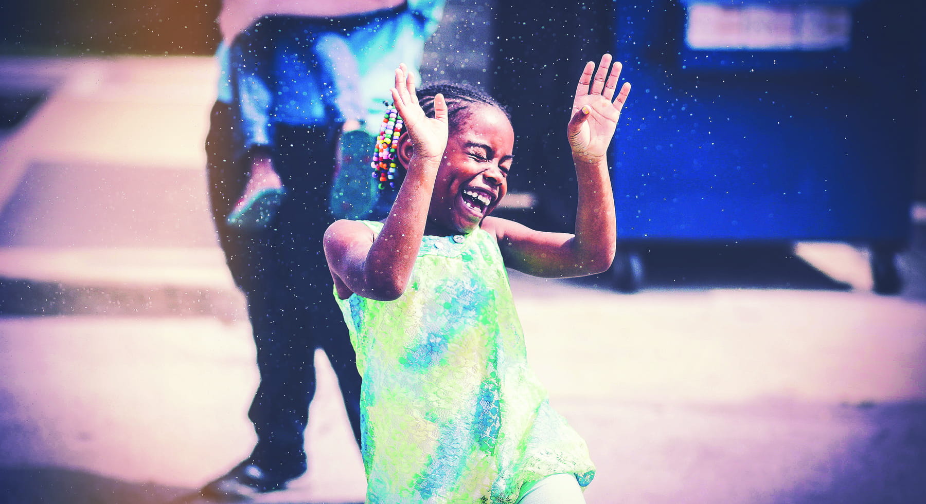 An image of a young girl playing in water