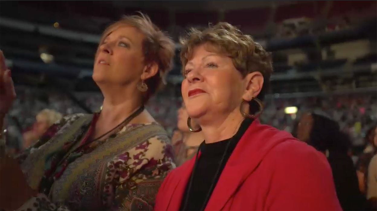 2 women watching Joyce from the crowd