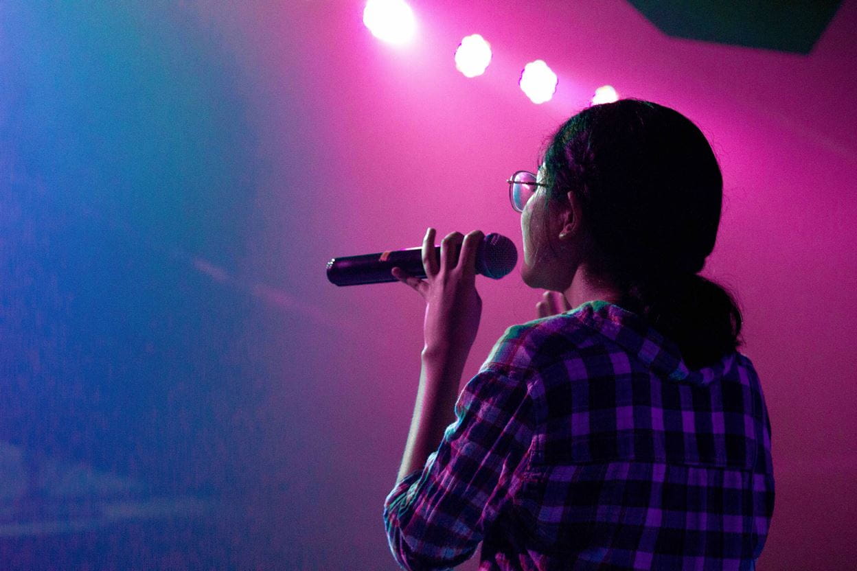 A women singing on stage