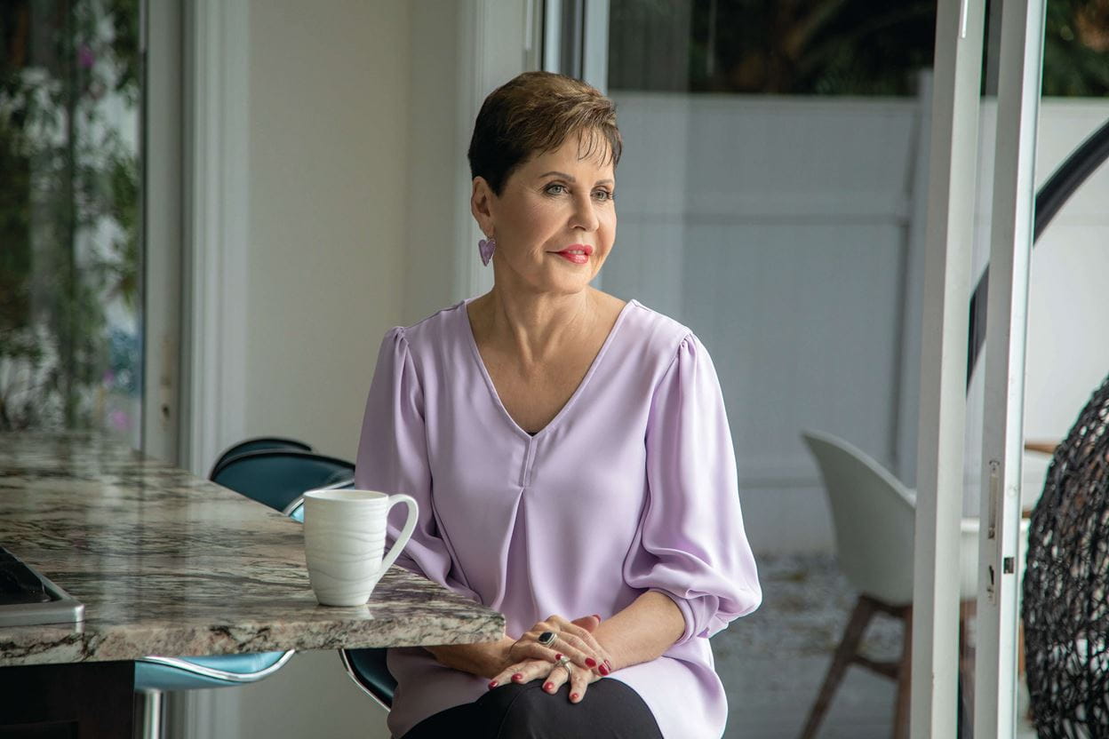 Joyce Meyer sitting in front of a cup of Coffee