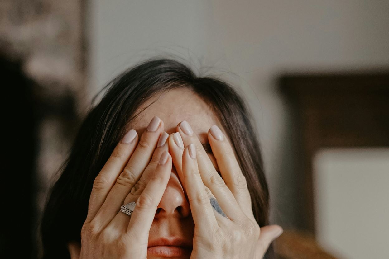 Women holding her face in exhaustion