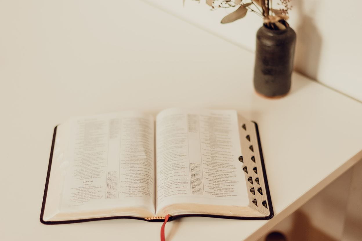An open Bible on a desk for reading a daily devotional.