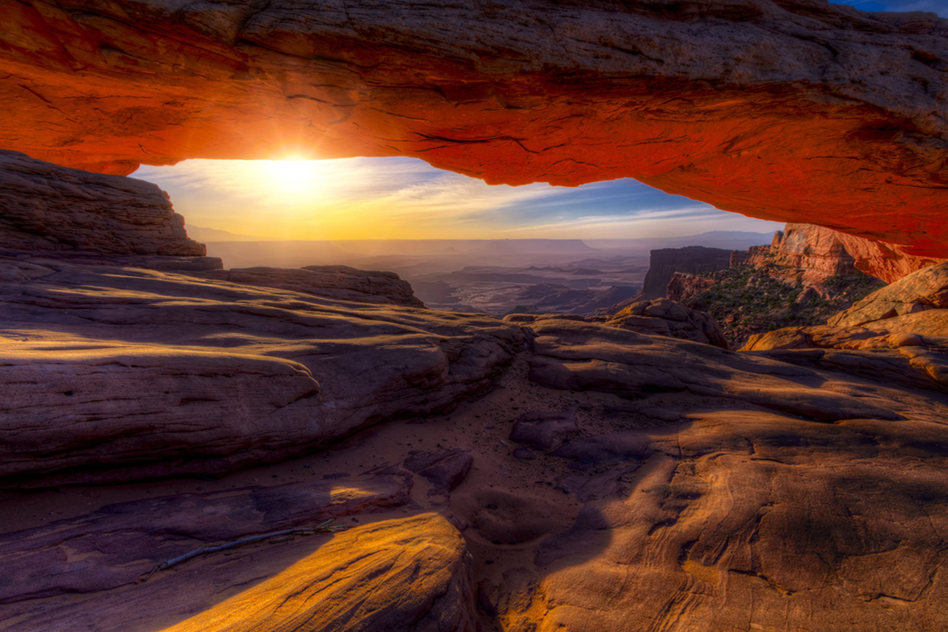A day starting with a sunrise under a rock arch.