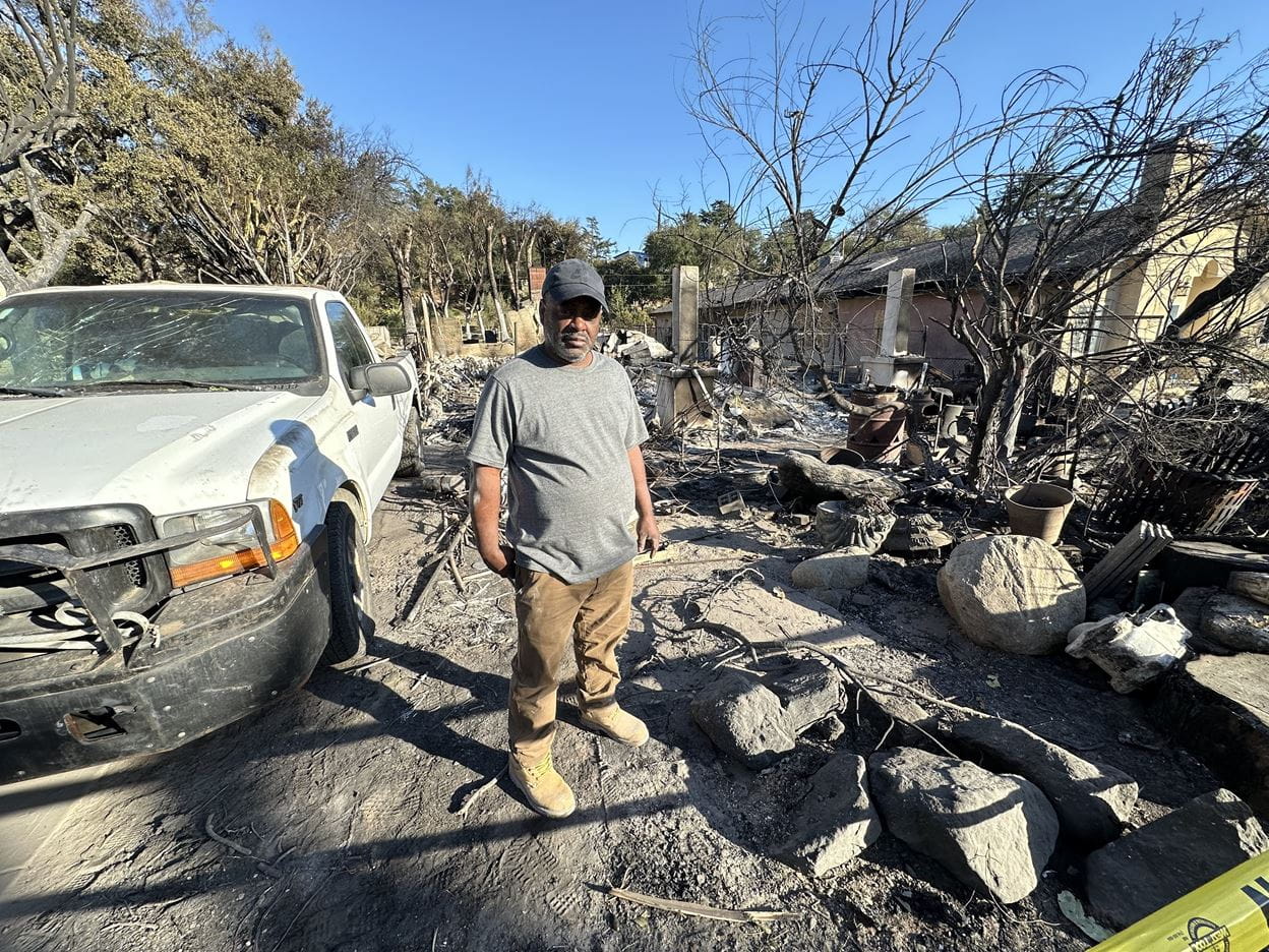 Man Standing in front of devastation due to fires in California