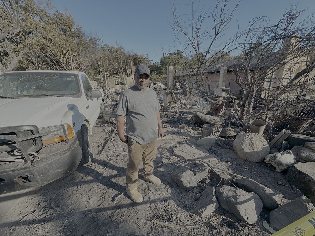 Man Standing in front of devastation due to fires in California