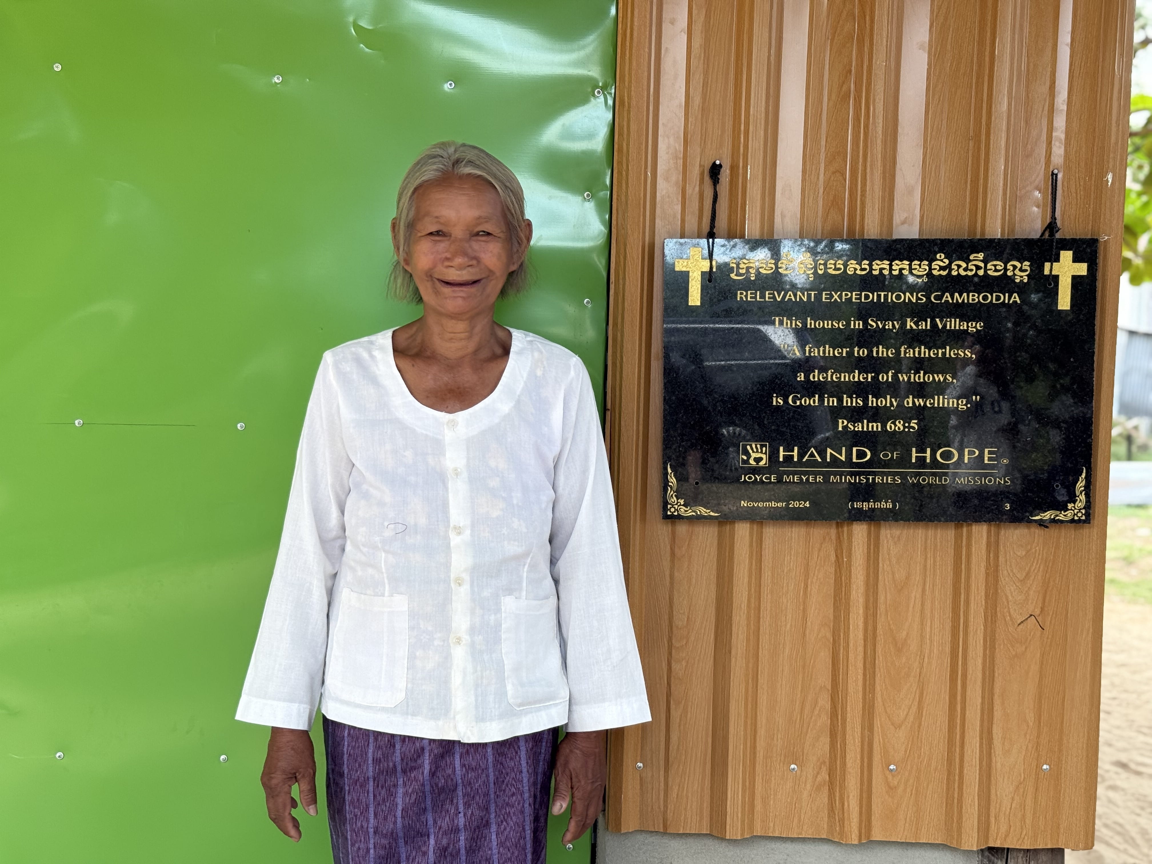 A women standing in front of sign